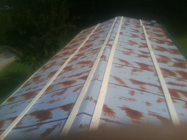 Rusted metal roof panels with new wood purlins before replacement — Storm Damage Roof Repair in Wagener by Roofing Brothers